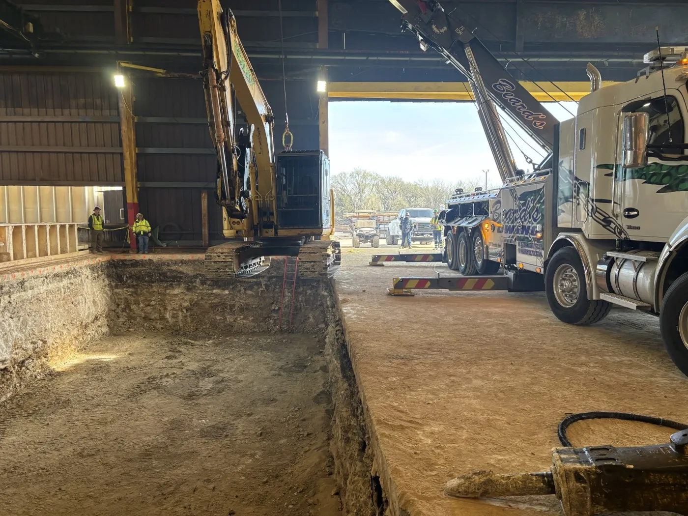 Excavator and support truck working an interior commercial demolition