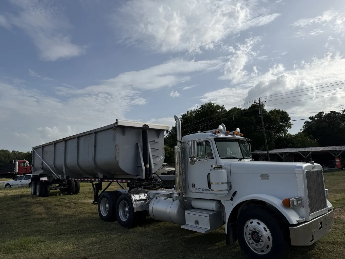 End dump trailer and truck staged for a debris haul