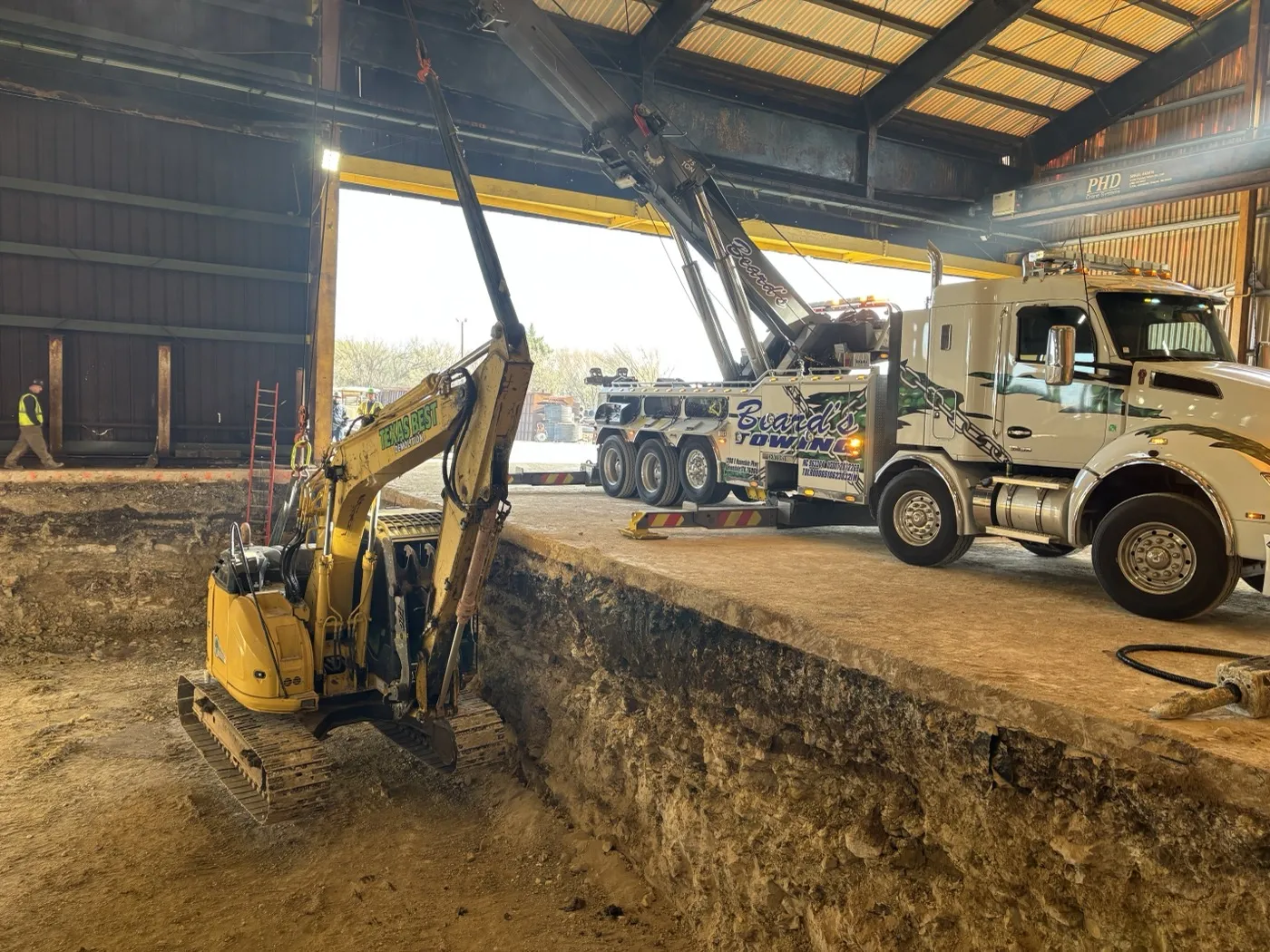 Mini excavator on a selective demolition dig inside a building